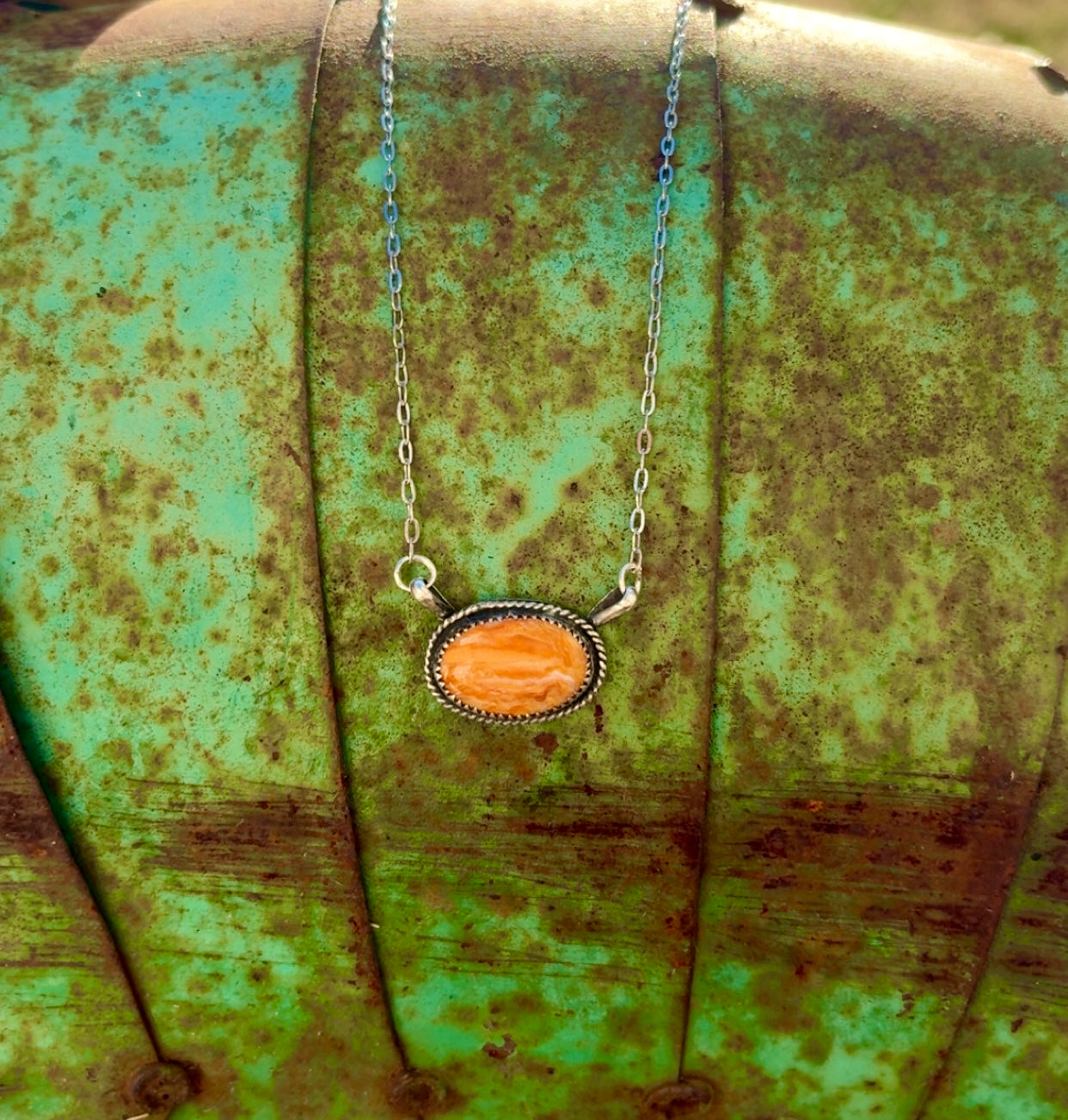 Orange spiny oval necklace