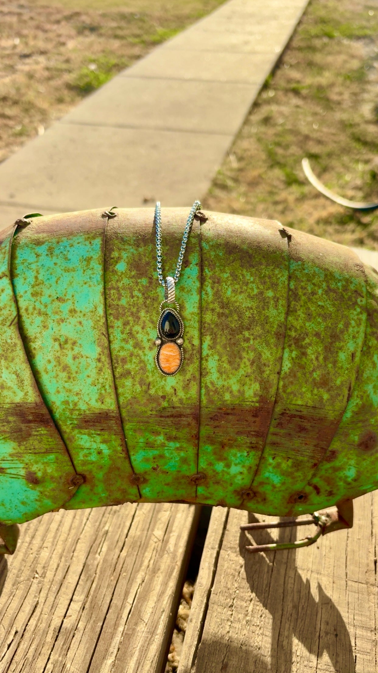 Orange spiny and black onyx pendent